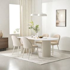 a white dining table with four chairs around it