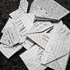 several pieces of paper with writing on them sitting on top of a carpeted floor