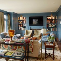 a living room filled with furniture and bookshelves