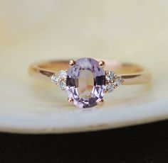 "This Engagement ring features a Lavender sapphire in oval cut. The sapphire is natural untreated, eye clean and sparkling. It is set in a 7-stone setting flanked by 6 diamonds. This ring would make a perfect engagement ring, anniversary ring or promise ring. The setting is 14k Rose gold, diamonds SI/H. Details: Center stone: Sapphire approx. 1.15ct (5x7mm)  natural, unheated, SI clarity Accented stone: Diamonds: SI/H, TDW 0.3ct This ring is ready to ship. We offer FREE SHIPPING Worldwide If you Purple Sapphire Engagement Ring Stac, Affordable Purple Promise Ring, Luxury Lavender Rings With Accent Stones, Single Stone Purple Engagement Rings, Luxury Lavender Oval Ring, Amythest Ring Simple, Luxury Lavender Rings With Gemstone Accents, Luxury Lavender Oval Amethyst Ring, Luxury Lavender Promise Ring