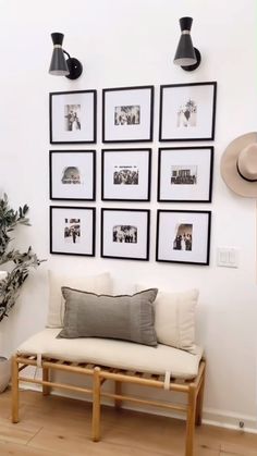 a living room with pictures on the wall and a bench in front of it,