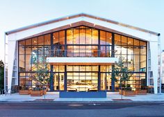 a large building with many windows and plants