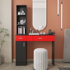 a modern bathroom with orange walls and white accents, including a red vanity table surrounded by grey chairs