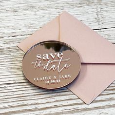 save the date magnet on top of an envelope with a pink envelope and white paper