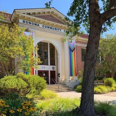 the front entrance to sonoma community center with trees and bushes in front of it