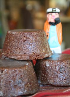 some brownies are stacked on top of each other with a toy man in the background