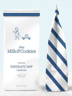 a bag of milk and cookies next to a tie on a white tablecloth with blue stripes