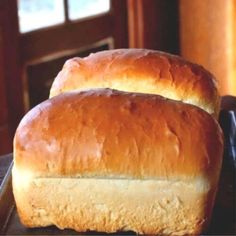 two loafs of bread sitting on top of a pan