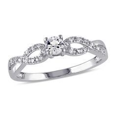 a white gold ring with an oval cut diamond surrounded by small round brilliant czrs