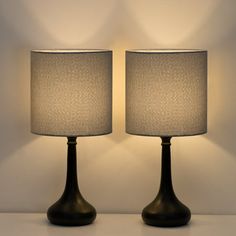 two lamps sitting next to each other on a table