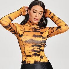 Be Bold, Be Wild With Our Wild Tiger Strip Top , Features A Tiger Stripe Design, Long Sleeves, Mock Turtleneck Style. The Women's Wild Tiger Print Long Sleeve Tie Dye Turtleneck Top Is A Fierce And Fashionable Choice For Any Woman. The All-Over Tiger Print Is Sure To Turn Heads, And The Tie-Dye Pattern Adds A Touch Of Whimsy. The Long Sleeves And Turtleneck Provide Warmth And Coverage, While The Fit Is Comfortable And Flattering. Features: Type: Top Sizes:S,M,L Color: Black & Orange Material: 83 Fitted Orange Tops, Casual Multicolor High Neck Tops, Fitted Multicolor Top For Fall, Fitted Long Sleeve Orange Top, Trendy Orange Winter Tops, Fitted Orange Winter Tops, Fitted Orange Top For Fall, Trendy Orange Fall Tops, Button Hoodie