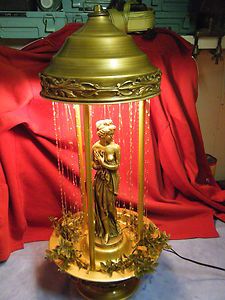 a lamp with a statue on top of it