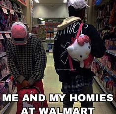 two people with hello kitty backpacks are walking down the aisle in a grocery store