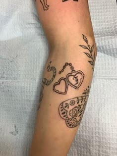 a woman's arm with tattoos on it, including an elephant and heart shapes