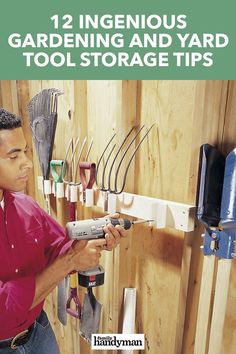 a man holding a tool in his hand while working on a garden and yard tool storage