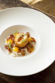 a white plate topped with food on top of a wooden table