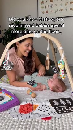 a woman laying on top of a bed next to a baby in a crib