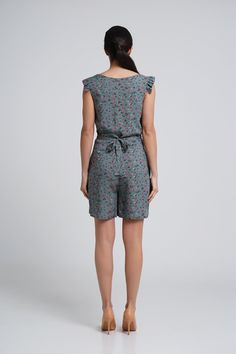 "A lightweight short summer romper feturing v-neckline, short ruffled sleeves and a shift silhouette. - V neck - short ruffled sleeves - shift silhouette - front button closure - two pockets in side seams - fabric belt - mini length (above the knee) - flower print Fiber: 100 % viscose Color: dark green For Size S (06 US): length - 34\" (87 cm) You may feel free choosing the size. Just send us your measurements (bust, waist, hips, height)." Casual Floral Print V-neck Jumpsuits And Rompers, Casual Printed V-neck Jumpsuits And Rompers, Green V-neck Jumpsuits And Rompers For Summer, Green V-neck Jumpsuit For Summer, Summer Vacation Short Jumpsuits And Rompers, Casual Summer Jumpsuits And Rompers With Ruffles, Chic Short Sleeve Jumpsuits And Rompers With Floral Print, Summer Printed V-neck Jumpsuit, Chic Floral Print Jumpsuit With Short Sleeves