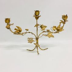 a golden flower arrangement on a white background with no people around it or in the photo