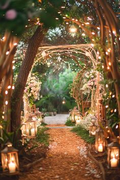 an outdoor wedding ceremony with candles and flowers on the aisle, surrounded by greenery