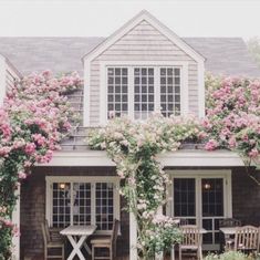 a house with pink flowers on the outside