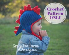 a young child wearing a crochet hat with spikes