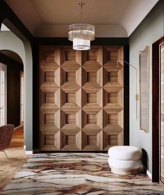 an elegant entry way with wood paneling on the walls