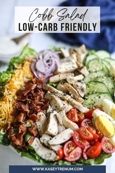 cobb salad with chicken, lettuce, tomatoes and cucumbers on it