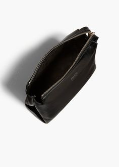 A lightweight pouch shaped by sculptural folds along the sides. The extended zipper closure allows allows for full access to the interior. Modern Black Clutch In Soft Leather, Modern Black Soft Leather Clutch, Modern Black Clutch With Zipper Closure, Modern Formal Clutch With Zipper Pocket, Black Leather Clutch With Zipper Closure, Modern Evening Clutch With Zipper Pocket, Black Shoulder Bag With Zipper Pouch For Evening, Black Evening Shoulder Bag With Zipper Pouch, Modern Evening Pouch With Zipper Closure