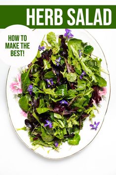 a white plate topped with greens and purple flowers