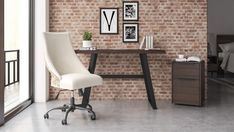 an office chair sitting in front of a brick wall with pictures on it and a desk