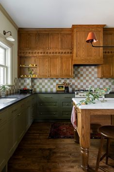 a kitchen with green cabinets and white counter tops