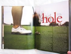 an open magazine with a person's foot in the grass