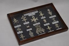 a display case with many different types of metal objects on it's sides and names