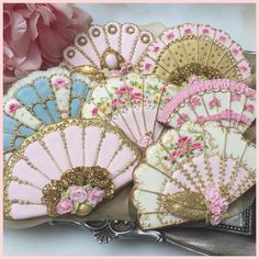 decorated cookies in pink, blue and gold with flowers