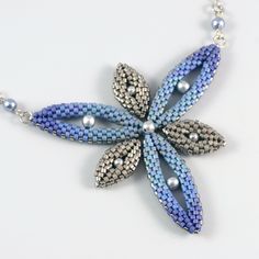 a beaded necklace with blue and silver beads hanging from it's center star