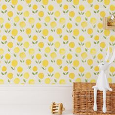 a yellow wallpaper with lemons on it and a white rabbit figurine