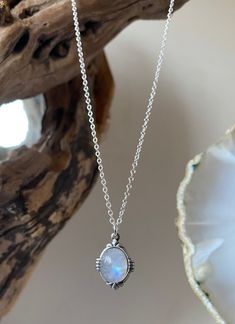 Classic handmade silver necklace with a large high quality beautiful rainbow moonstone that is known to be a stone of love that provides calmness & protection.  This is a simple but stunning necklace that has beautiful curved detailing around the edge.  I handpick all the moonstone stones and no two are identical as they are all natural stones. The moonstones vary in colour and some are more milky than others and some are more transparent with flashes of blue/ the spectrum. If you have a specific requirement please message me as I can see what stones I have in stock and can handpick one just for you.  This necklace is a classic vintage everyday piece that is very wearable and it makes a beautiful simple statement as well as being a pretty piece of jewellery to dress an outfit up. The neckl Mystical White Moonstone Necklaces, Mystical White Moonstone Necklace, White Labradorite Necklace With Natural Stones, White Moonstone Crystal Necklace With Moon Charm, Handmade Silver Moonstone Crystal Necklace, Bohemian Round Moonstone Necklaces, White Mystical Gemstone Necklace, Bohemian Moonstone Round Necklaces, Dainty Moonstone Necklace With Natural Stones