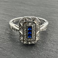 Vintage Blue & White Cubic Zirconia Sterling Silver Statement Ring, UK Size R1/2, US Size 9, EU Size 59 1/4, Stamped 925, Front Max Width 14.6mm, Weight 4.30 Grams, Lovely Condition Art Deco Blue Diamond Ring With Accents, Blue Art Deco Diamond Ring With Accents, Art Deco Blue Cubic Zirconia Rings, Blue Cubic Zirconia Art Deco Rings, Blue Diamond Ring, Art Deco Style, Gift, Blue Cubic Zirconia Sapphire Ring Channel Set, Blue Sapphire Ring With Cubic Zirconia Channel Set, Blue Art Deco Diamond Ring As A Gift, Blue Sapphire Ring With Channel Set Cubic Zirconia