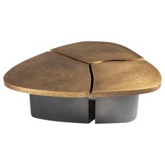 an artistically designed coffee table with two black bases and gold leaf design on the top