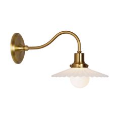 an antique brass wall light with a white glass shade