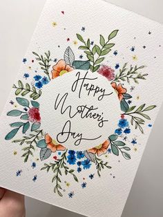 a hand holding up a card that says happy mother's day