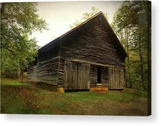 an old log cabin in the woods with grass and trees around it's sides