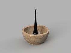 a wooden bowl with a black spoon in it