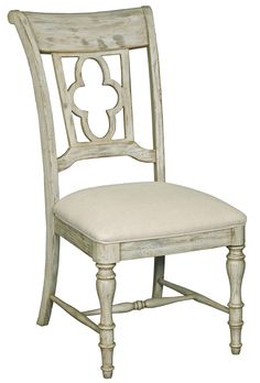 a white wooden chair with a beige upholstered seat and back cushion on an isolated white background