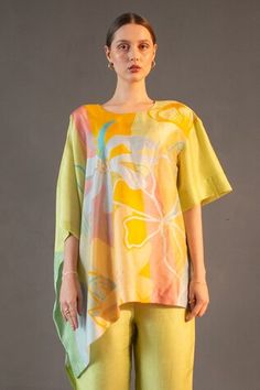 Lime asymmetric kaftan with abstract geometric and floral print. Paired with striped straight pant. - Aza Fashions Spring Tunic Sets With Printed Motifs, Spring Printed Tunic Sets, Spring Silk Tunic Set, Multicolor Summer Tunic Sets, Spring Asymmetrical Sets, Printed Tunic Sets For Summer, Summer Printed Tunic Sets, Spring Yellow Tops With Printed Motifs, Chic Sets With Asymmetrical Hem For Spring