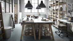 an industrial style kitchen with wooden shelves and hanging lights