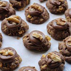 chocolate cookies with walnuts and nuts on a baking sheet, ready to be eaten