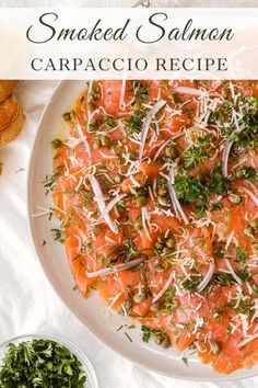 smoked salmon carpaccio recipe on a white plate with parmesan cheese and herbs