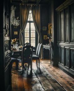 a dining room with wooden floors and black walls